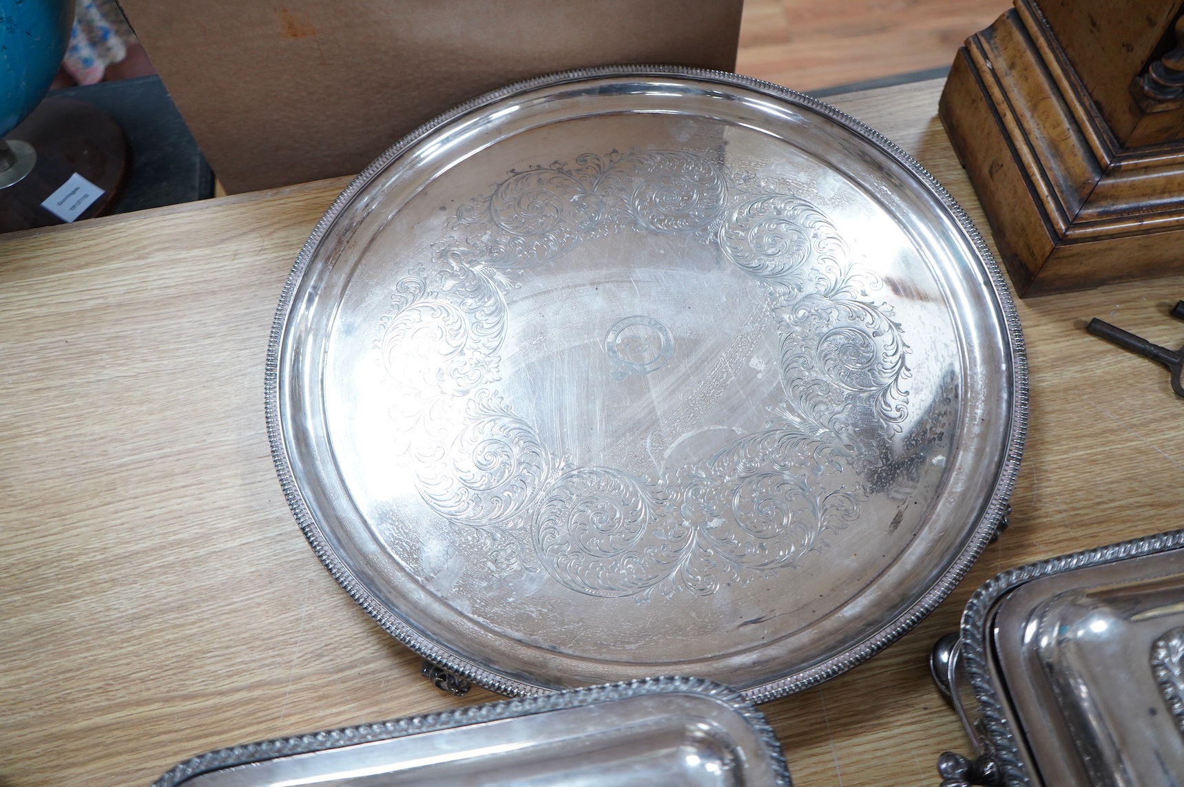 A pair of silver plated entrée dishes, an egg coddler and salver